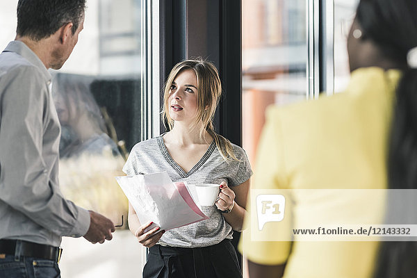 Business people talking at the window in office