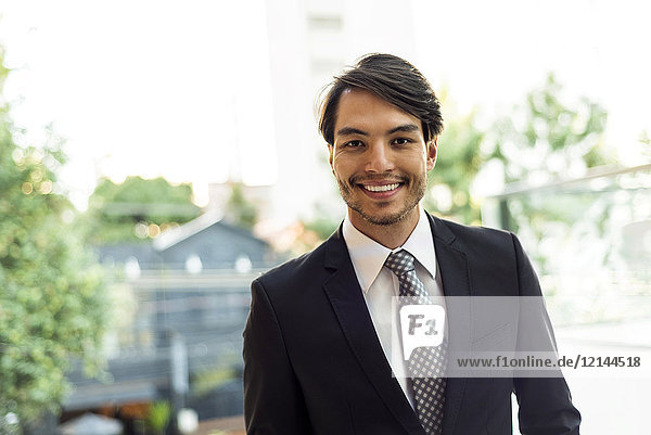 Portrait of smiling businessman outdoors