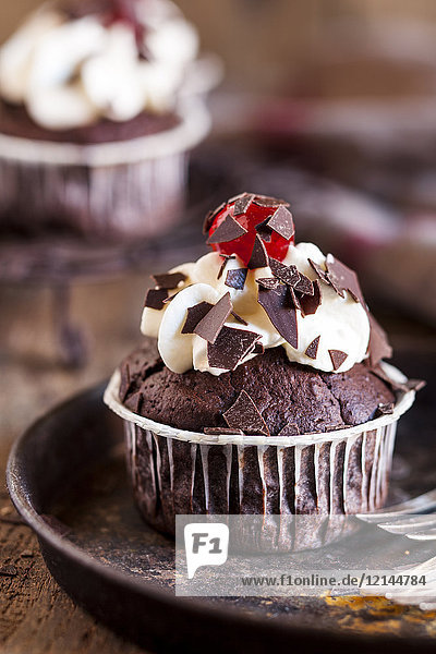 Black forest cherry muffins with cream topping and cherry