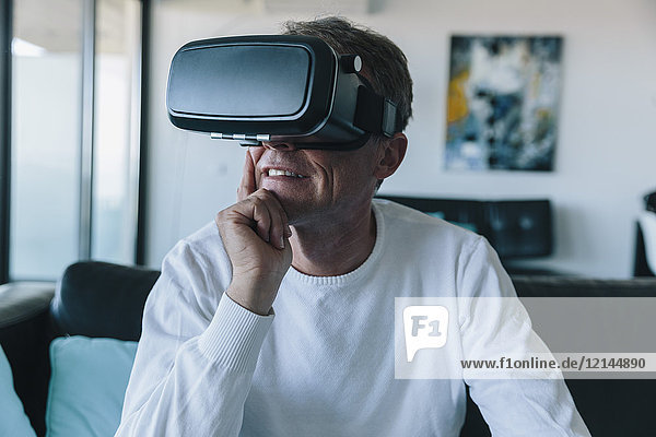 Man wearing VR glasses in an apartment