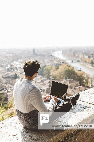 Italy  Verona  tourist using laptop  observation point