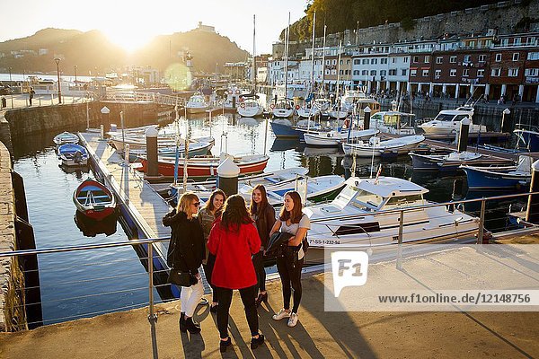 Group of tourists and guide making a tour of the city  Port  Donostia  San Sebastian  Gipuzkoa  Basque Country  Spain  Europe
