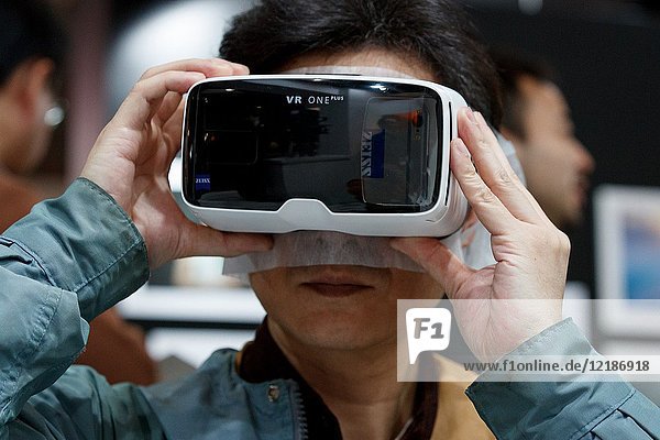 March 3  2018  Yokohama  Japan - A man tries out a ZEISS VR One Plus (Virtual Reality Headset) at the CP+ Camera & Photo Imaging Show 2018 in Pacifico Yokohama. Japan's largest camera and photo imaging exhibition bring together 1 123 exhibitor booths during the four-day trade show at the Pacifico Yokohama and OSANBASHI Hall. Organizers expect approximately 70 000 visitors until March 4th.