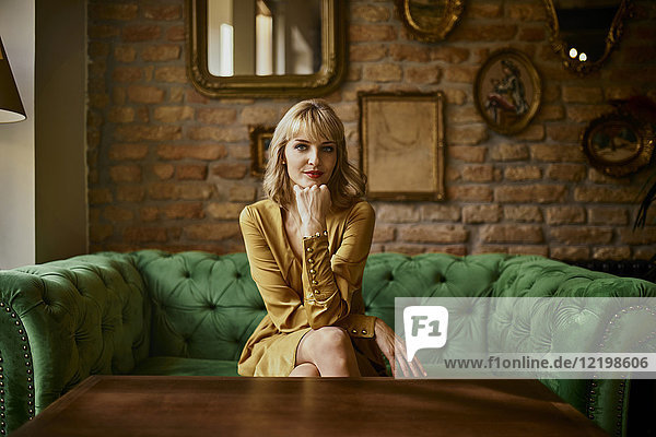 Portrait of elegant woman sitting on a couch