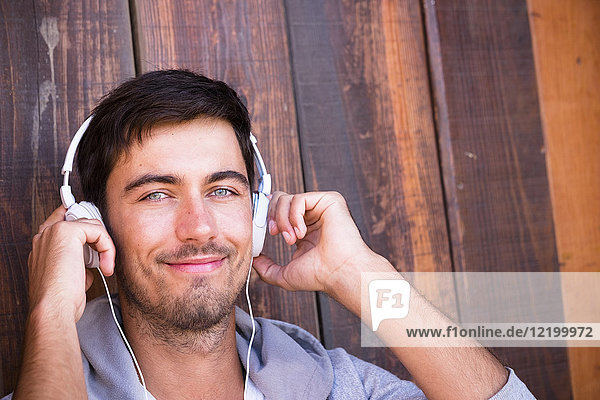 Portrait of smiling young man wearing headphones