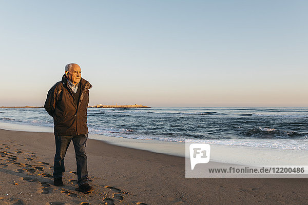 Senior man strolling at the beach