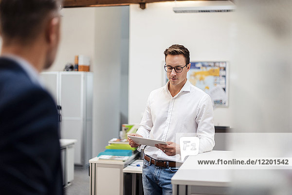 Young businessman using tablet in office
