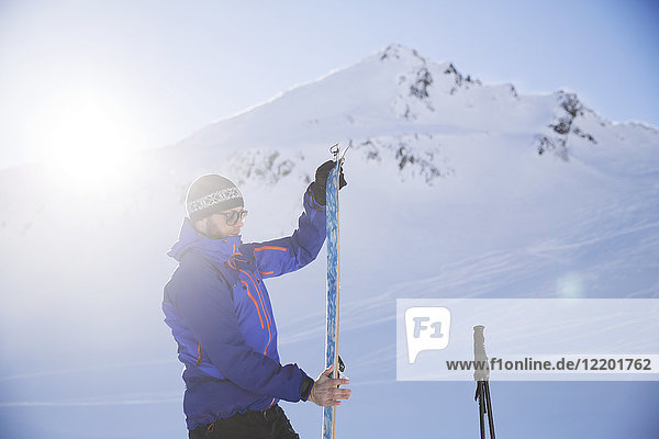 Austria  Tyrol  Kuehtai  freeride skier preparing ski for a ski tour