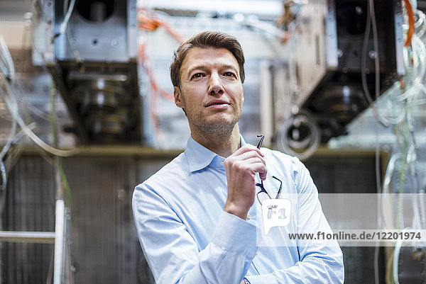 Portrait of confident businessman in factory