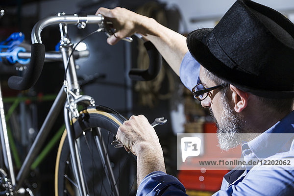Man working on bicycle in workshop