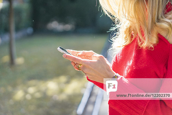 Close-up of woman using smartphone in a garden