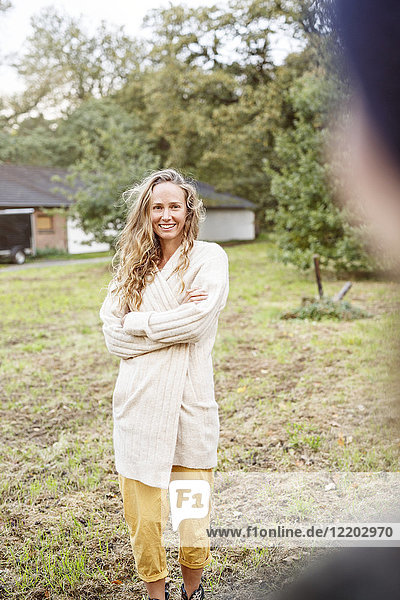 Portrait of smiling blond woman in rural landscape