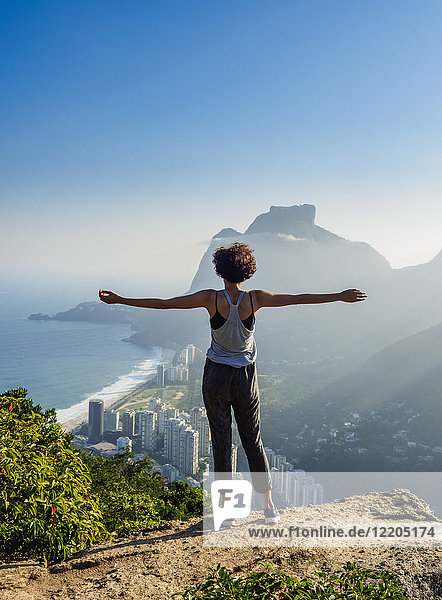 Brazilian girl looking towards the Pedra da Gavea and Sao Conrado from Dois Irmaos Mountain  Rio de Janeiro  Brazil  South America