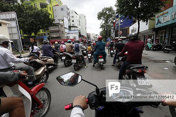 Vietnamese people on motorbikes in traffic  Ho Chi Minh City  Vietnam  Indochina  Southeast Asia  Asia