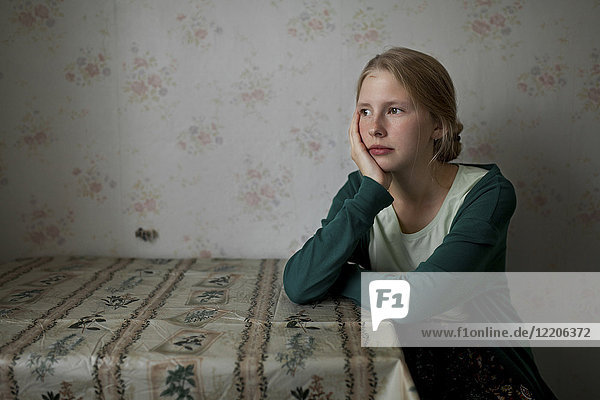 Portrait of pensive Caucasian woman leaning on table