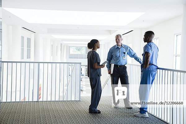 Doctor and nurses talking near staircase