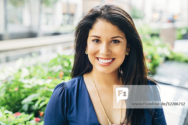 Close up portrait of smiling Hispanic woman