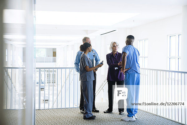 Doctors and nurses talking near staircase