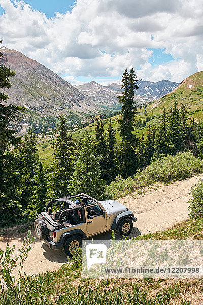 Roadtrip-Ehepaar fährt Cabrio-Geländewagen auf ländlicher Bergstraße  Breckenridge  Colorado  USA