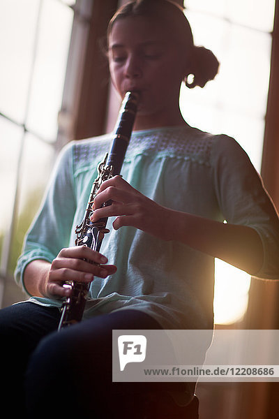 Young clarinettist playing her clarinet