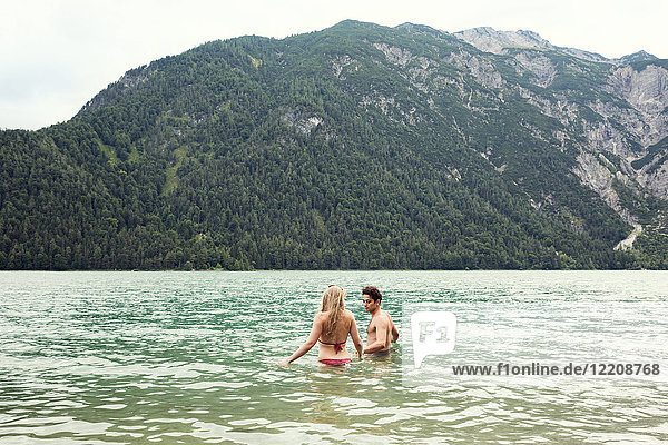 Couple waist deep in water  Achensee  Innsbruck  Tirol  Austria  Europe