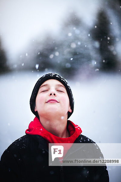 Portrait of boy in falling snow