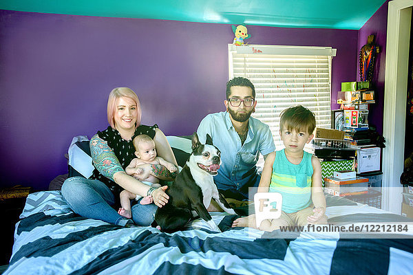 Family on bed in bedroom
