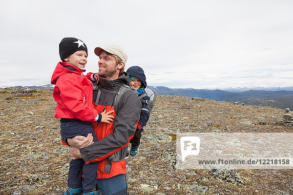 Male hiker with sons in mountain landscape  Jotunheimen National Park  Lom  Oppland  Norway