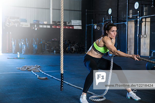 Woman exercising in gymnasium  sled training