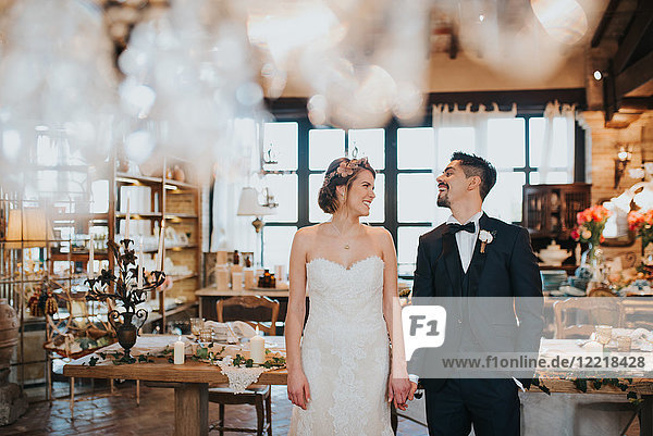 Bride and bridegroom in dining room of wedding reception