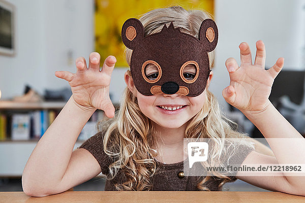 Portrait of young girl wearing bear mask