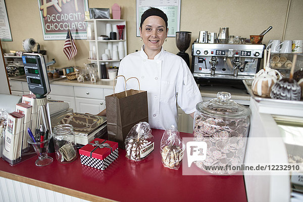 Portrait of Caucasian woman owner of a candy shop.