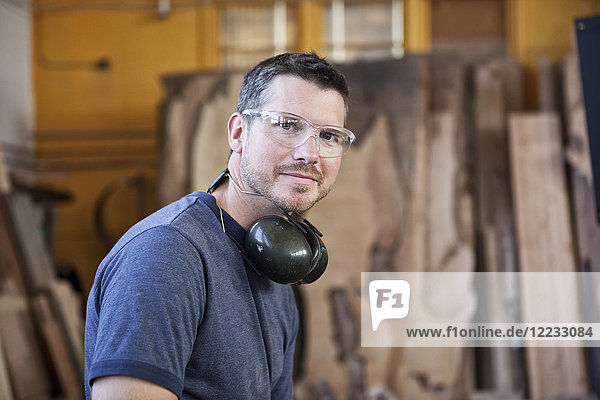 View of a Caucasian man factory worker in a woodworking factory.