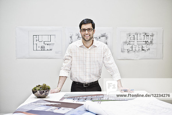 Hispanic man working in an architect's office.