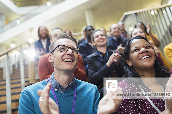 Laughing  happy conference audience clapping