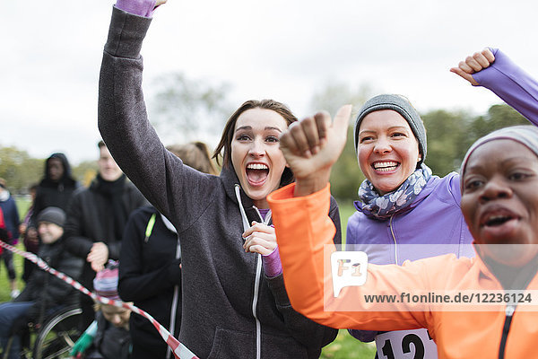 Enthusiastic female spectators cheering at charity run