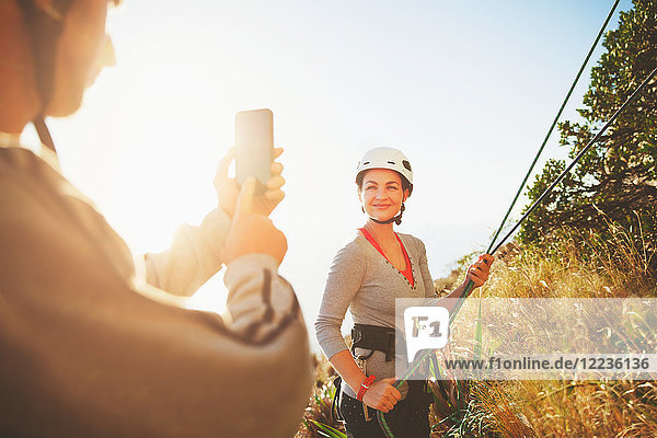 Female rock climber posing  being photographed