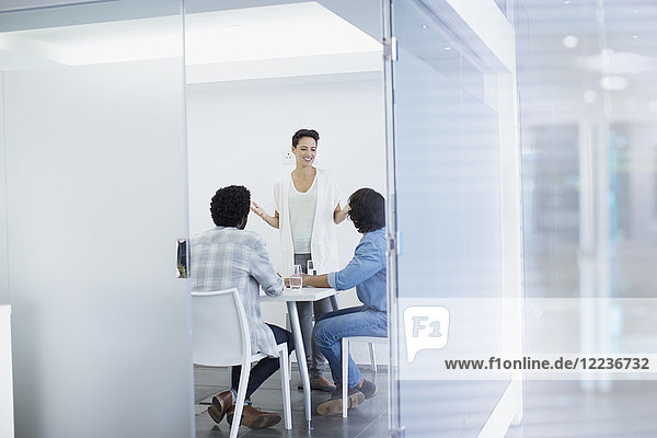 Businesswoman leading conference room meeting
