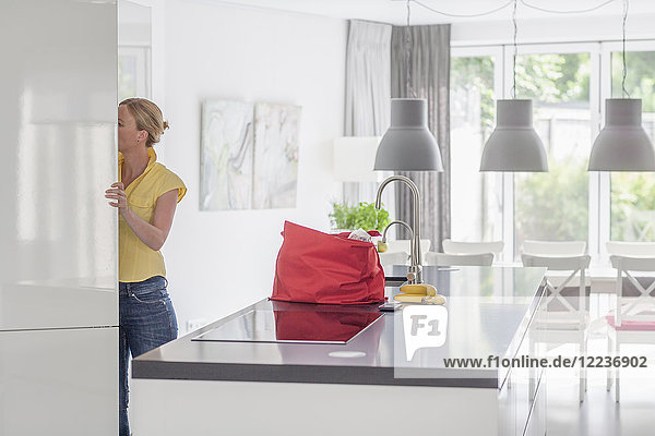Woman unpacking groceries from shopping bag