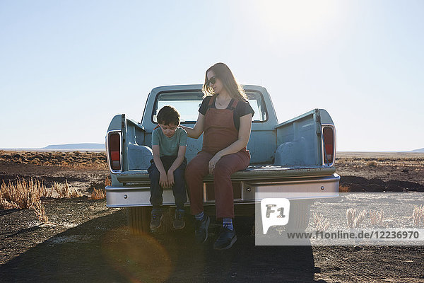 USA Arizona Mother comforting son (6-7) on tailgate of pick-up truck