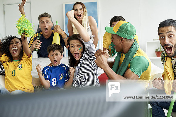 Brazilian soccer fans watching televised match together