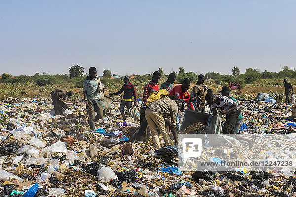 Local boys looking for valuables in the public rubbish dump  Niamey  Niger  Africa