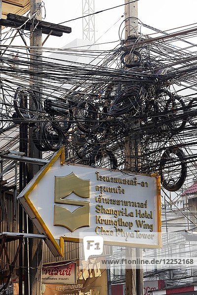 Post with cable tangle  chaotic cables  cable tangle  at the Thanon Charoen Krung  Bang Rak  Bangkok  Thailand  Asia