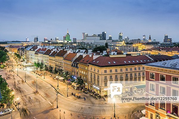 Main old street called Krakowskie Przedmiescie and modern office buildings in the downtown  twilight  Warsaw  Poland  Europe