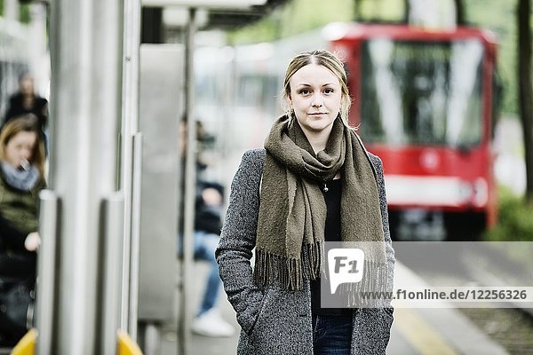 Young woman waiting for the train at a s-Bahn station  Germany  Europe