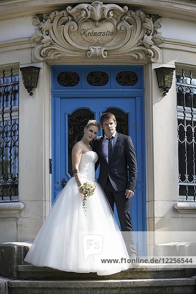 Young bridal couple posing on stairs  Switzerland  Europe