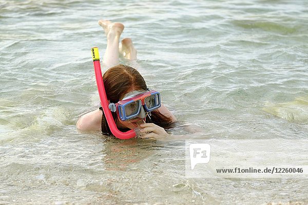 Young girl bathing  snorkeling with diving goggles  Sicily  Italy  Europe