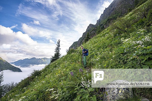 Hiker on hiking trail  ascent to Greifenberg  Schladminger Höhenweg  Schladminger Tauern  Schladming  Styria  Austria  Europe