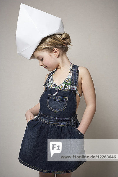 Fashionable little girl wearing big paper hat