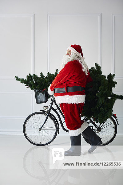Santa Claus carrying with bicycle